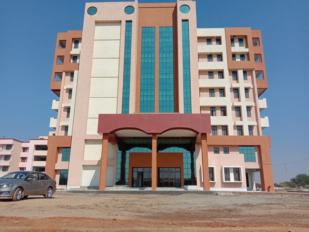 Completed multi-storey office building with a red and cream facade