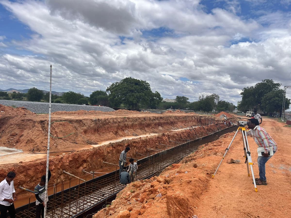 Surveyor checking levels on railway formation earthwork