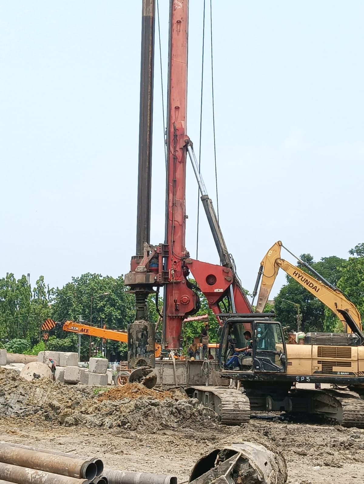 Piling rig and excavator working on a construction site