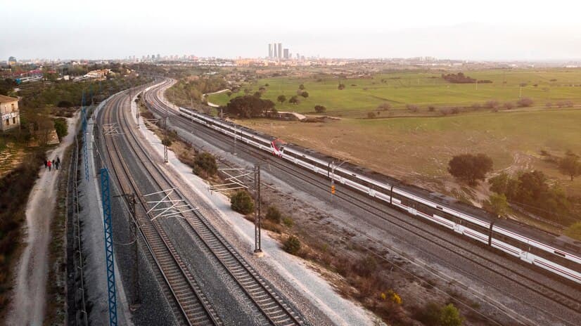 Aerial view of multiple railway lines curving through open countryside